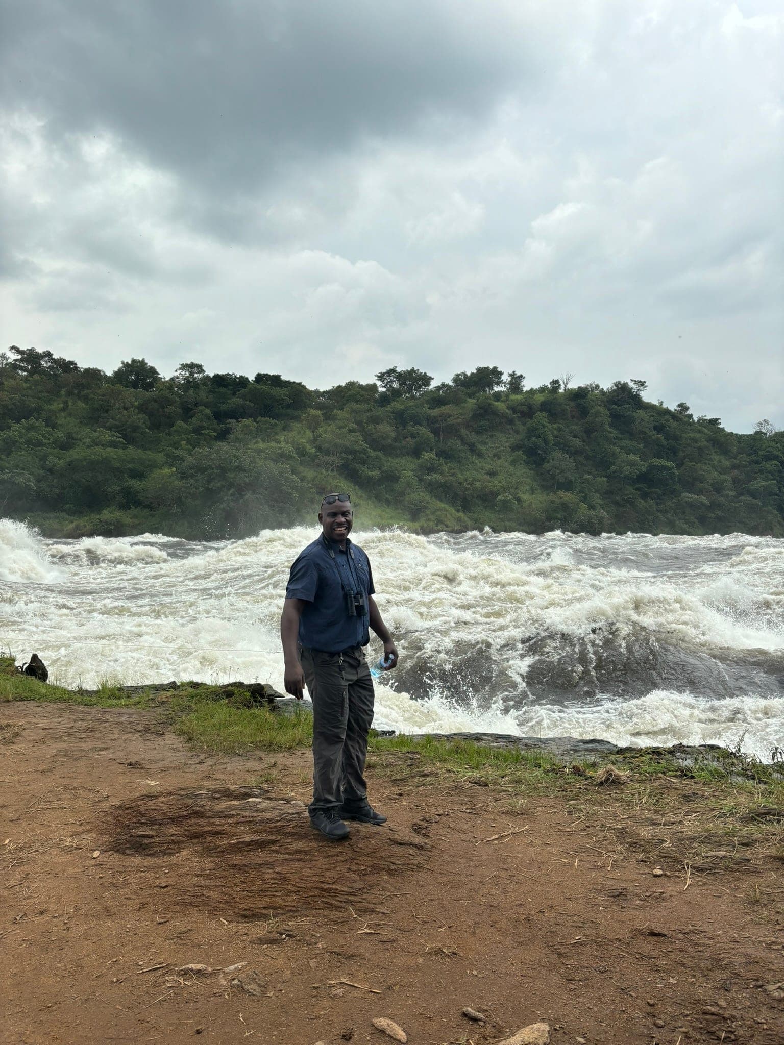 Amanya Godwin standing before Murchison Falls